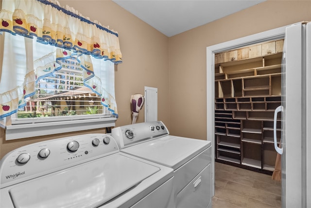 washroom featuring washing machine and dryer and light tile patterned floors