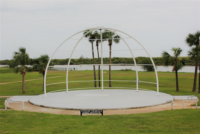 view of property's community with a yard and a water view