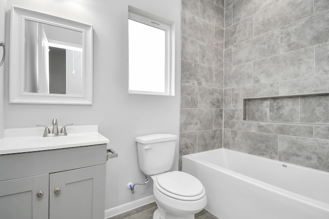 full bathroom with hardwood / wood-style floors, vanity, toilet, and tiled shower / bath