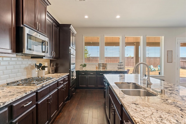 kitchen featuring appliances with stainless steel finishes, dark hardwood / wood-style floors, sink, and a healthy amount of sunlight