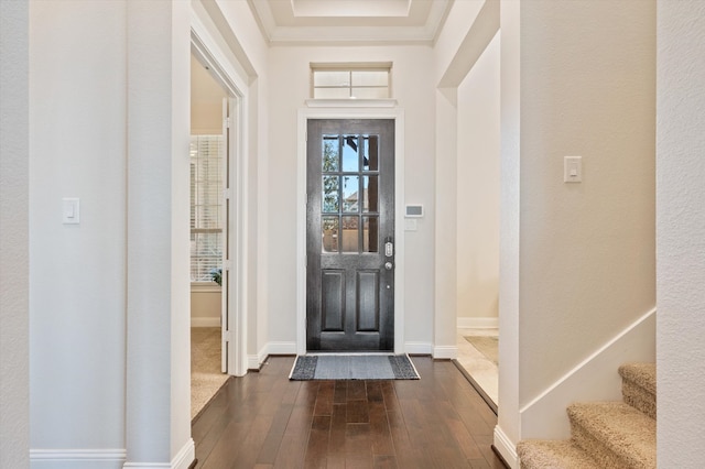 entryway with dark wood-type flooring and crown molding