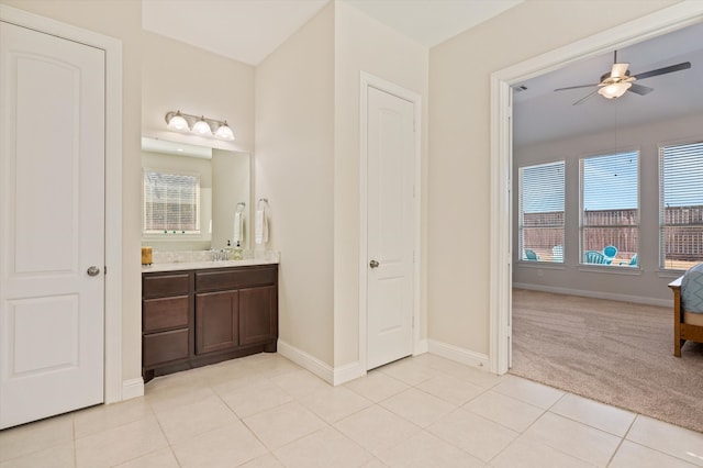 bathroom featuring tile patterned flooring, ceiling fan, and vanity