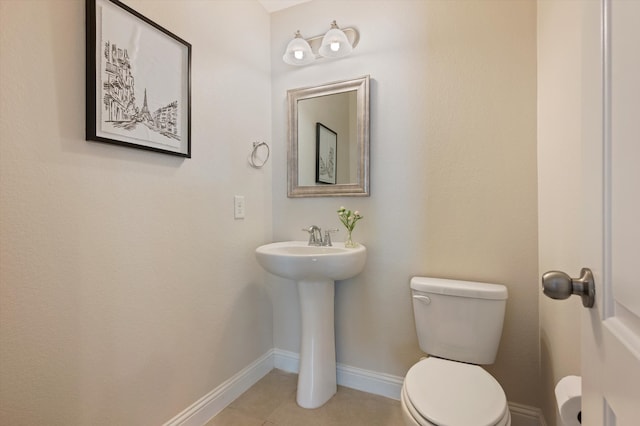 bathroom with toilet and tile patterned floors