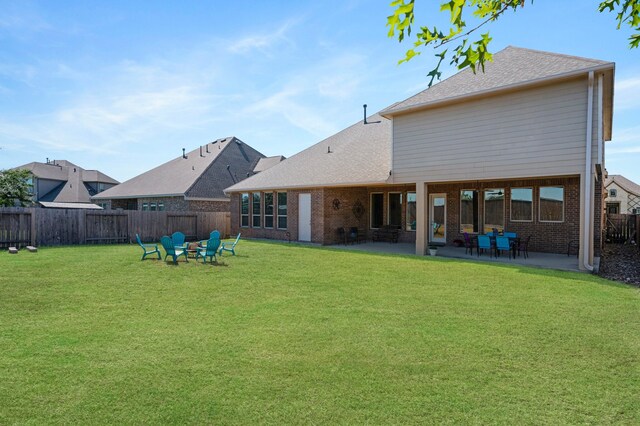 back of property with a patio and a yard