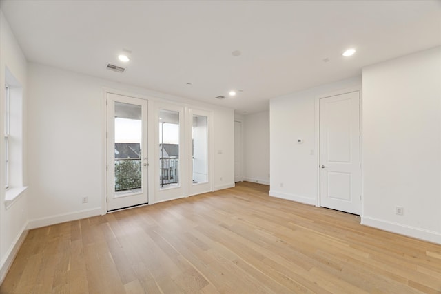 unfurnished room with light wood-type flooring