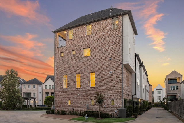 outdoor building at dusk featuring central air condition unit