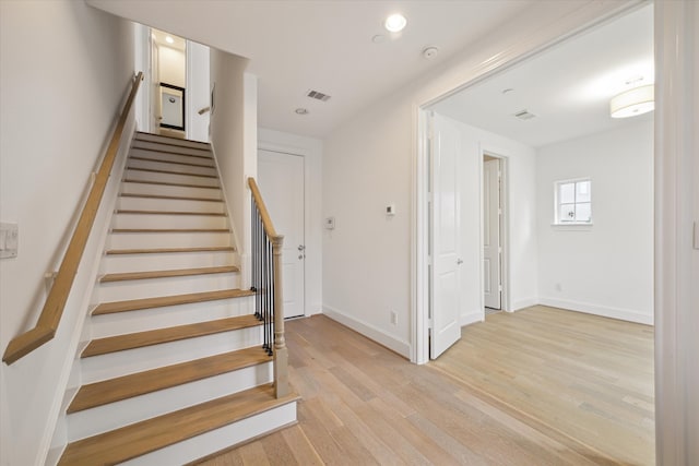 staircase featuring hardwood / wood-style flooring