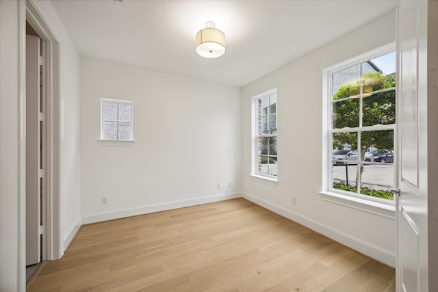 unfurnished bedroom with multiple windows and light hardwood / wood-style floors