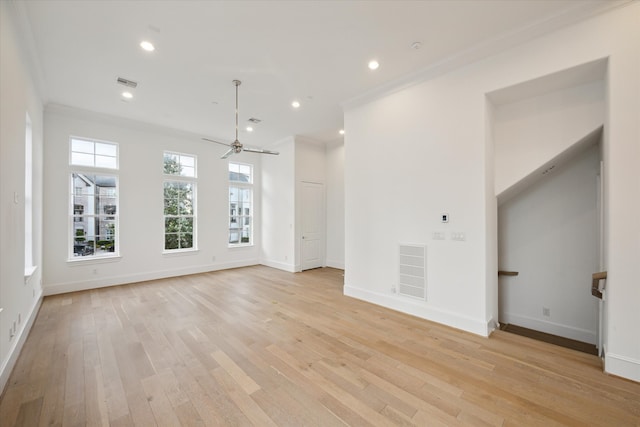 unfurnished living room with light hardwood / wood-style floors, ceiling fan, and crown molding