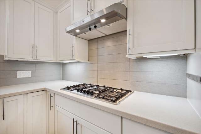 kitchen with white cabinets, stainless steel gas cooktop, and tasteful backsplash