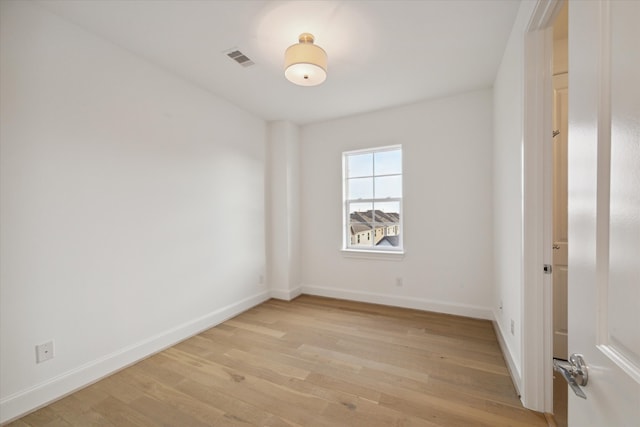 spare room with light hardwood / wood-style flooring