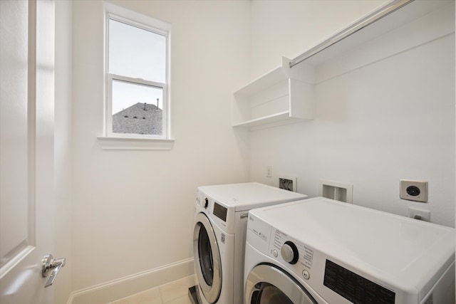 laundry area with light tile patterned floors and independent washer and dryer