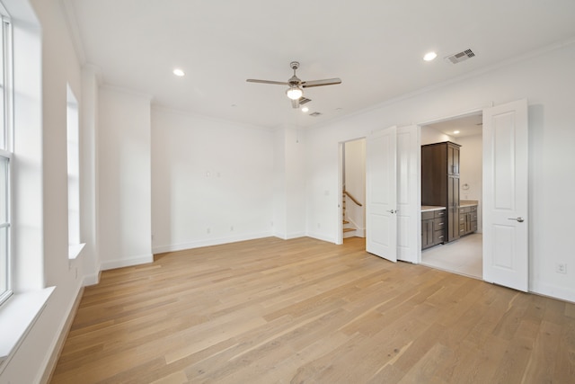 spare room with light hardwood / wood-style floors, ornamental molding, and ceiling fan