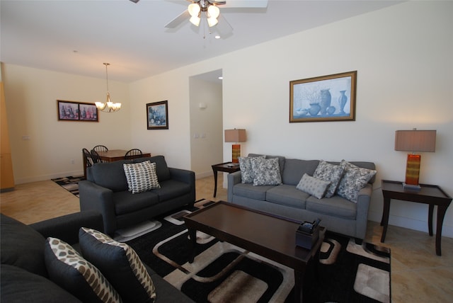 living room featuring ceiling fan with notable chandelier and light tile patterned flooring