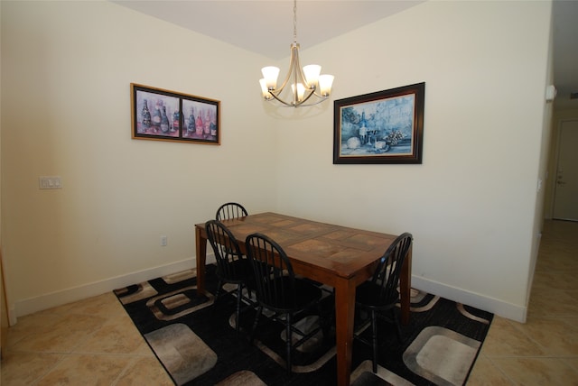 tiled dining room with a chandelier