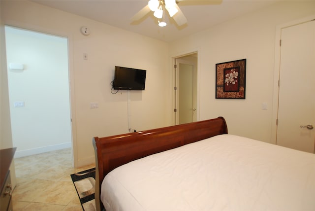 tiled bedroom featuring ceiling fan