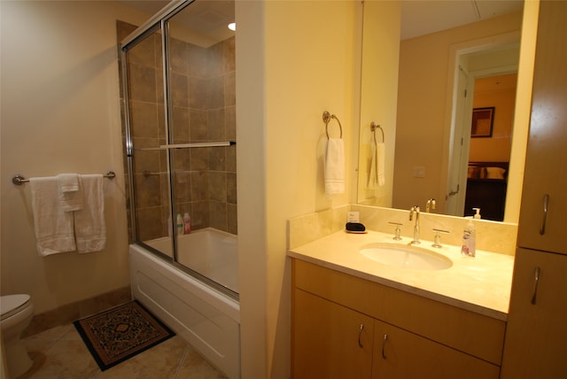 full bathroom featuring tile patterned flooring, combined bath / shower with glass door, vanity, and toilet