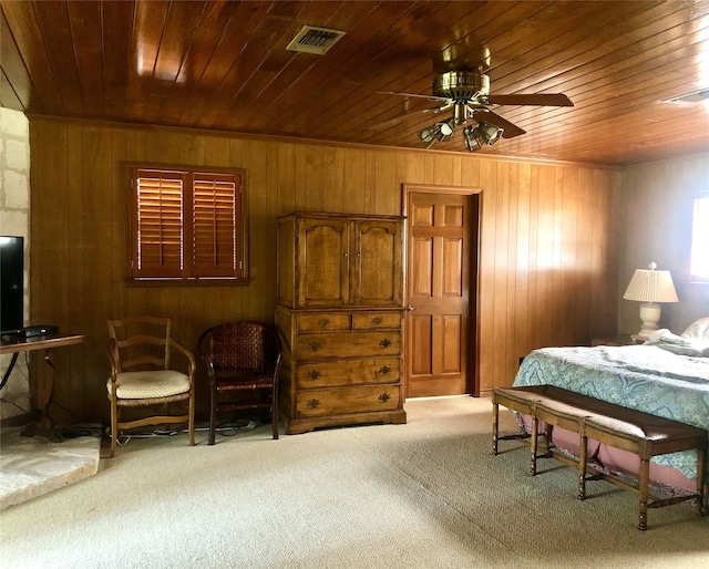 bedroom with wood ceiling, wood walls, light carpet, and ceiling fan