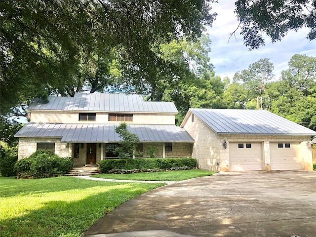 view of front facade with a front yard and a garage