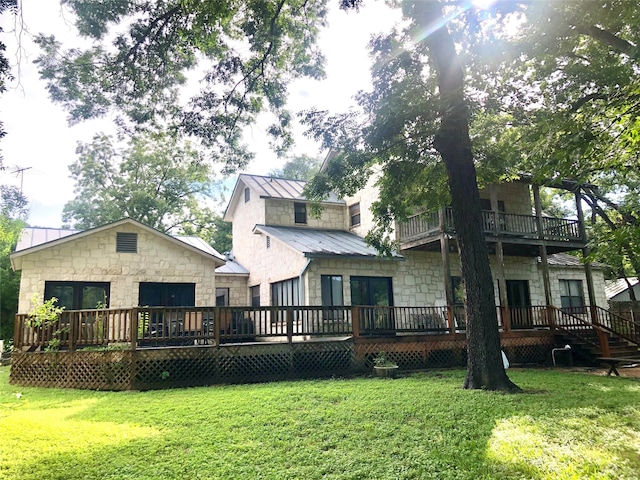 back of house with a lawn and a deck