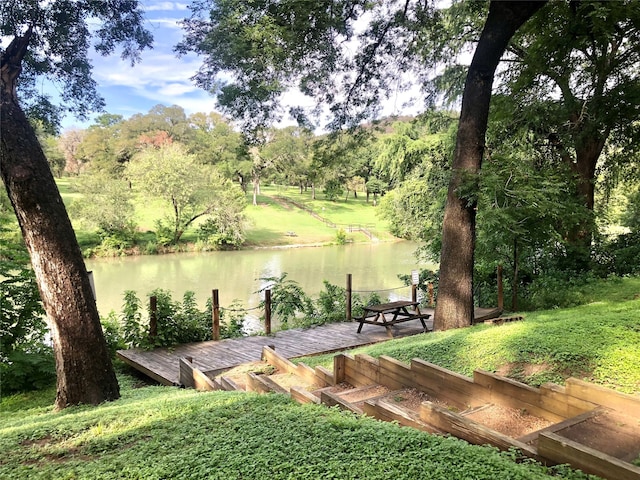 view of property's community with a boat dock and a water view