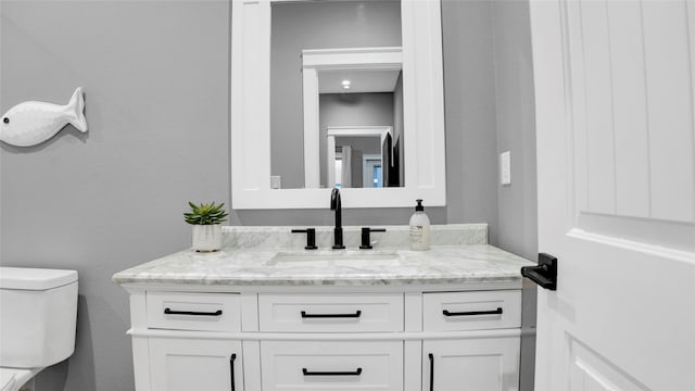 bathroom featuring vanity and toilet