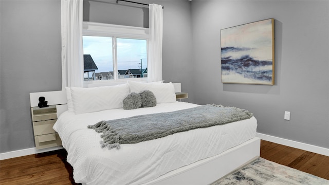 bedroom with dark wood-type flooring