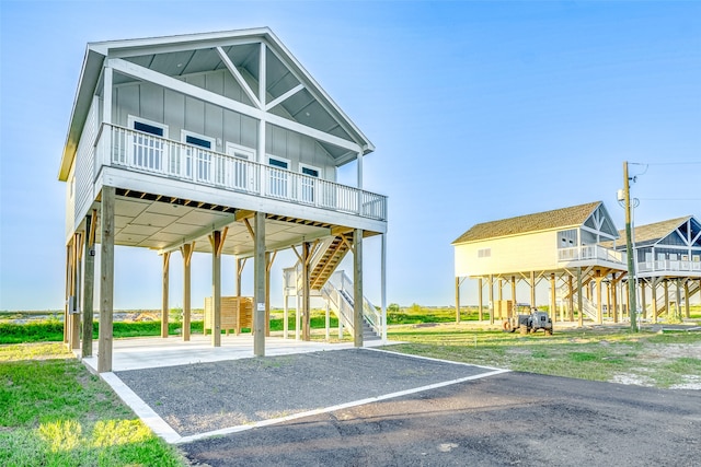 view of parking with a lawn