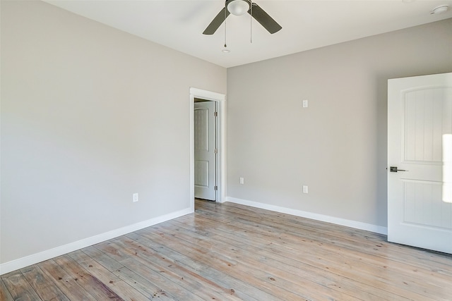 spare room with ceiling fan and light wood-type flooring