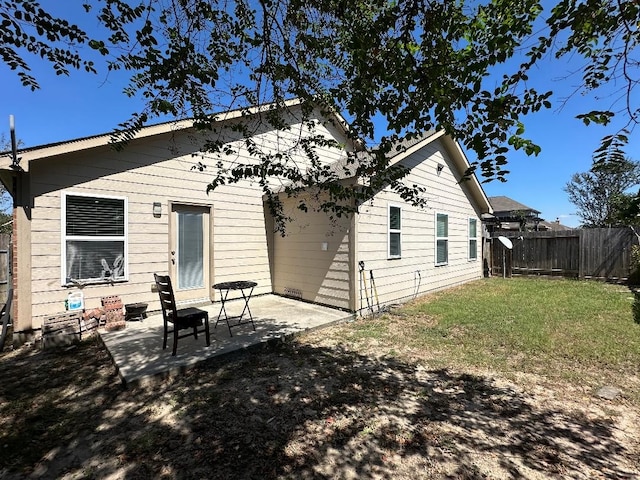 back of property with a patio and a lawn