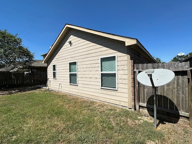 view of side of property with a lawn