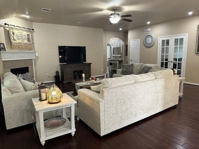 living room with ceiling fan, french doors, and dark hardwood / wood-style flooring