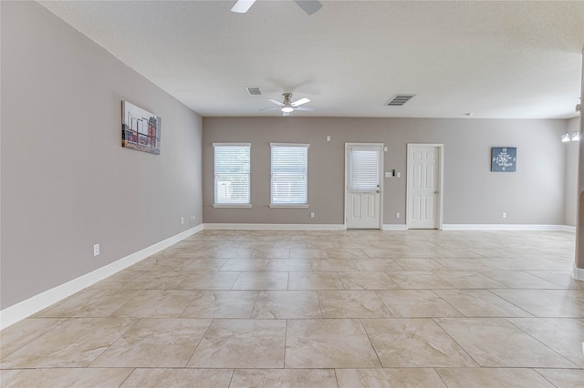 unfurnished room with ceiling fan, a textured ceiling, and light tile patterned flooring