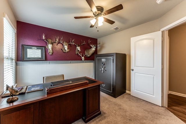 office space featuring light carpet and ceiling fan