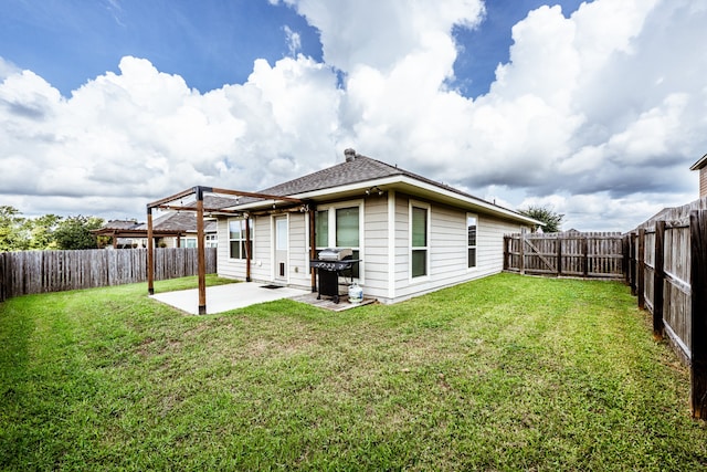 back of house featuring a patio area and a yard