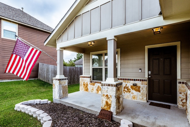 property entrance with a lawn and a porch