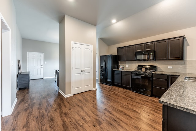 kitchen featuring black appliances, dark brown cabinets, dark hardwood / wood-style floors, and tasteful backsplash