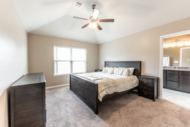 carpeted bedroom with lofted ceiling, ceiling fan, and ensuite bathroom