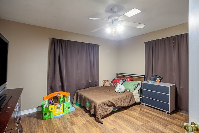 bedroom with ceiling fan and light hardwood / wood-style floors