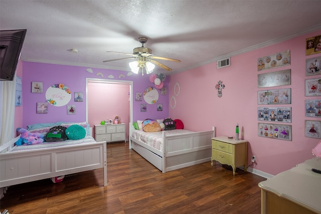 bedroom featuring a textured ceiling, ornamental molding, dark hardwood / wood-style floors, and ceiling fan