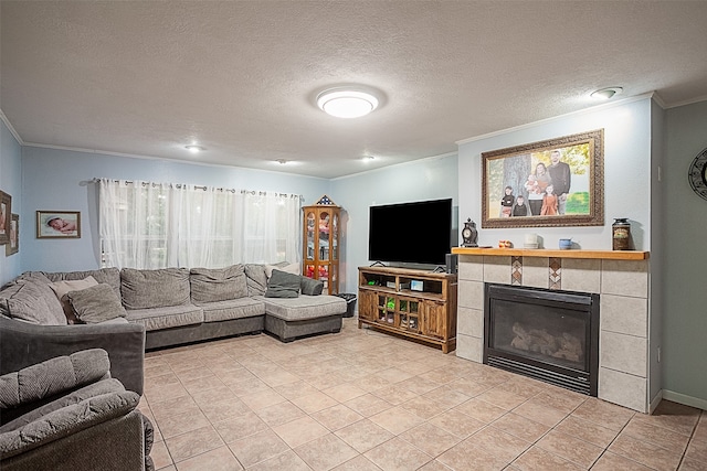 tiled living room with a textured ceiling, ornamental molding, and a tile fireplace