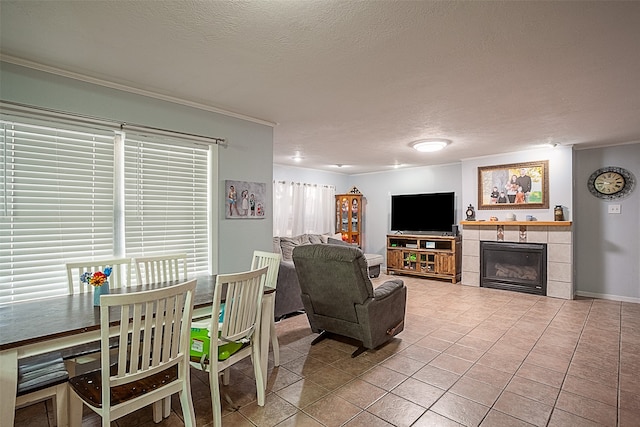 tiled living room with a textured ceiling, a fireplace, and crown molding