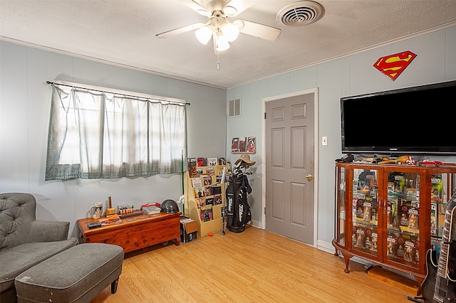 sitting room featuring a textured ceiling, ceiling fan, and hardwood / wood-style flooring