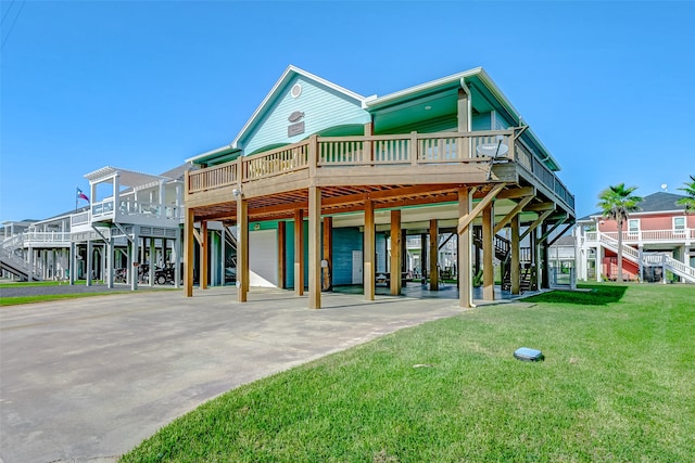 back of house with a garage, a deck, and a yard