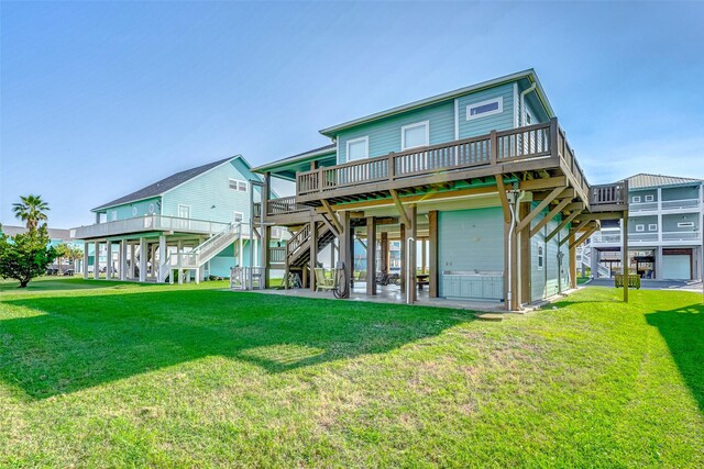 rear view of property with a lawn, a wooden deck, stairs, and a patio