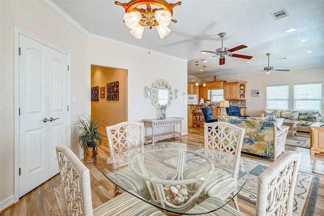dining space with light wood-style flooring, visible vents, ornamental molding, recessed lighting, and a ceiling fan