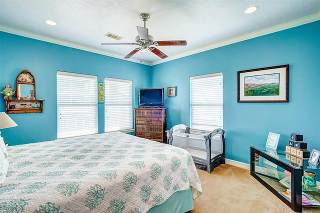 carpeted bedroom featuring baseboards, visible vents, multiple windows, and crown molding