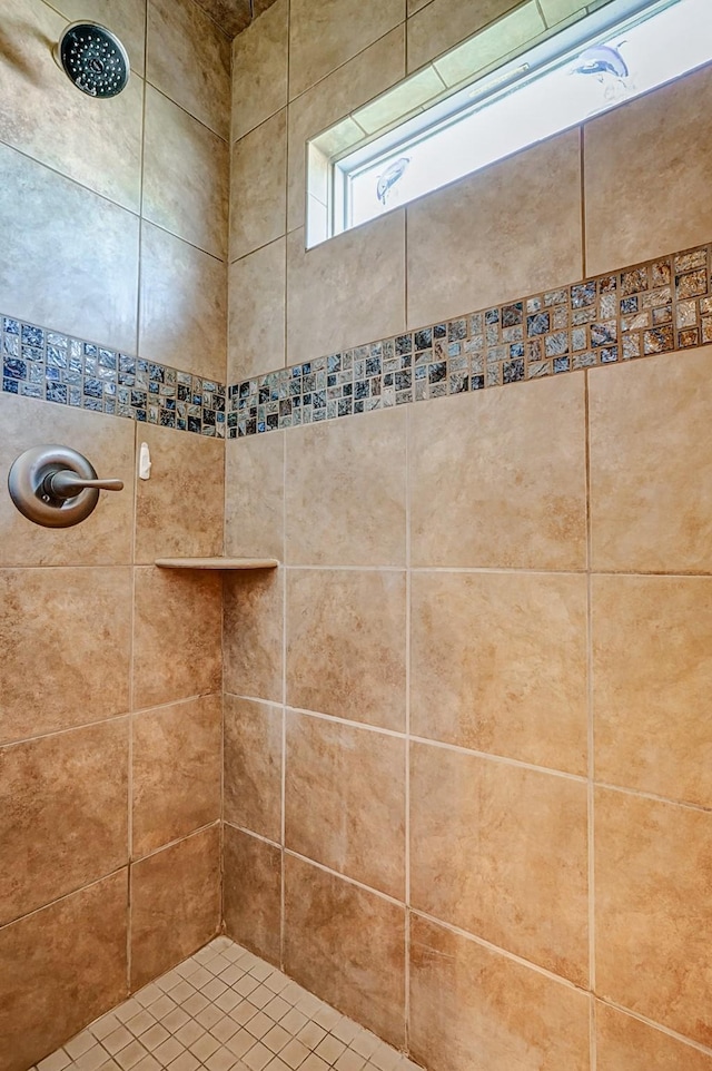 full bathroom featuring tiled shower