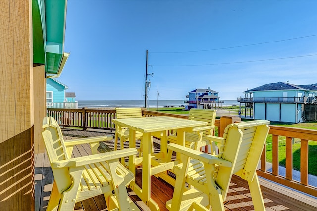 wooden terrace featuring a water view