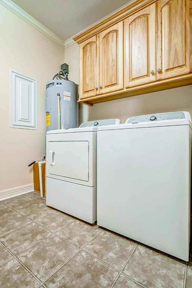 washroom featuring cabinets, electric water heater, light tile patterned flooring, crown molding, and washer and clothes dryer